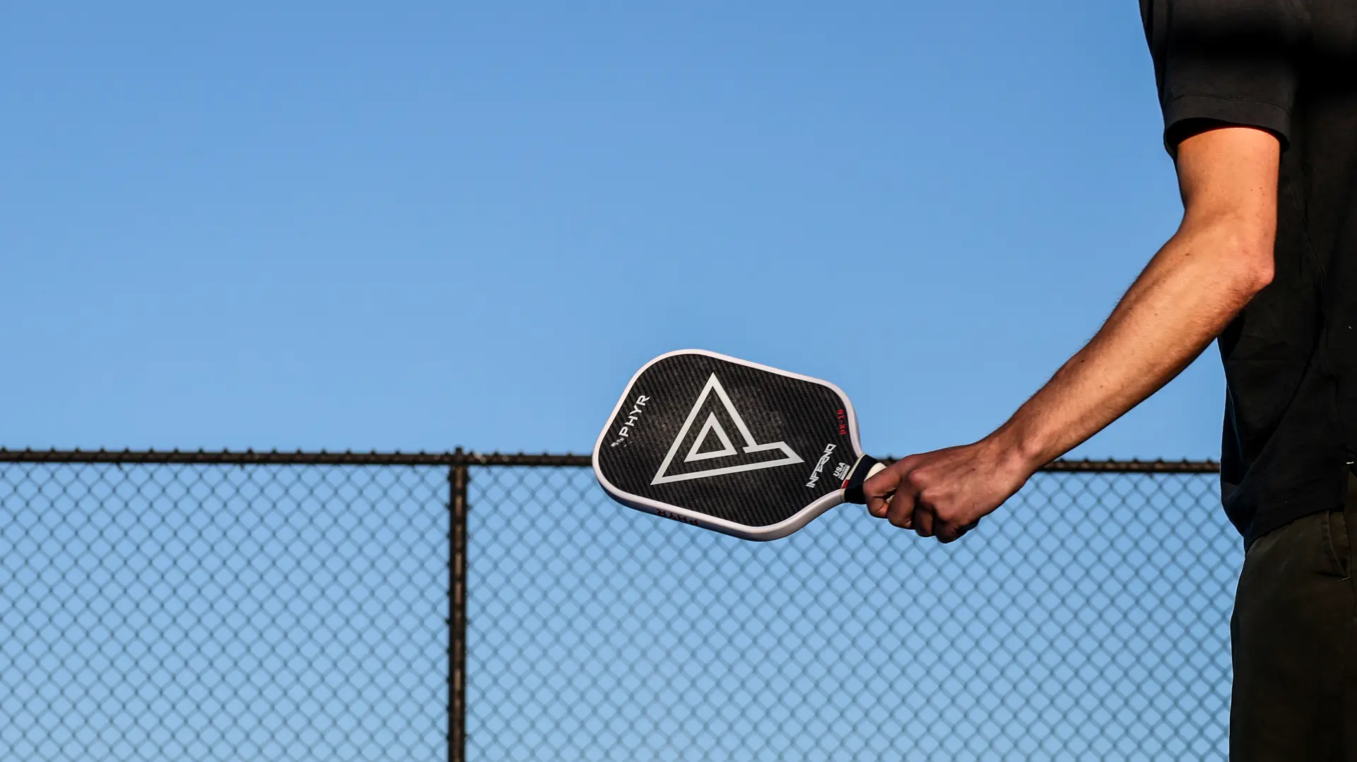 Inferno paddle handed over the court fence